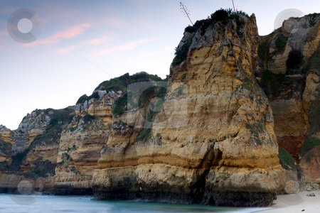 To use this stock image in your creative project, please select the size you need over to the right and click the "Add to Cart" button.
Your downloaded image will come with the Cutcaster watermark removed so don’t worry about the watermark you see on this page. Sheer rocky cliffs stock photo, The sheer rocky cliffs at the beaches of 'Praia Dona Ana' in Lagos, Portugal, with a setting sunlit sky. by Kevin Woodrow
