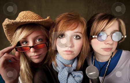 To use this stock image in your creative project, please select the size you need over to the right and click the "Add to Cart" button.
Your downloaded image will come with the Cutcaster watermark removed so don’t worry about the watermark you see on this page. Three Young Girls with Microphone stock photo, Portrait of three pretty young girls with a microphone on green background by Scott Griessel