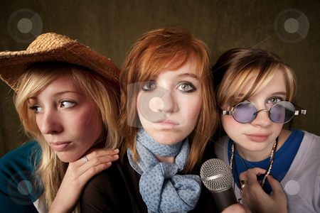 To use this stock image in your creative project, please select the size you need over to the right and click the "Add to Cart" button.
Your downloaded image will come with the Cutcaster watermark removed so don’t worry about the watermark you see on this page. Three Young Girls with Microphone stock photo, Portrait of three pretty young girls with a microphone on green background by Scott Griessel