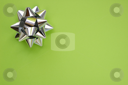 To use this stock image in your creative project, please select the size you need over to the right and click the "Add to Cart" button.
Your downloaded image will come with the Cutcaster watermark removed so don’t worry about the watermark you see on this page. Star on green stock photo, A decorative star, made from silver ribbon, on a plain green background with space for text (copy). by Alistair Scott