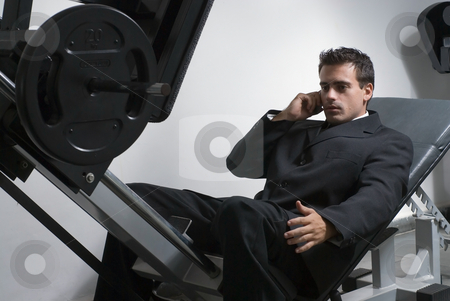 To use this stock image in your creative project, please select the size you need over to the right and click the "Add to Cart" button.
Your downloaded image will come with the Cutcaster watermark removed so don’t worry about the watermark you see on this page. Businessman at the Gym stock photo, Handsome businessman, wearing a suit, talking on cellphone in the gym. by Orange Line Media