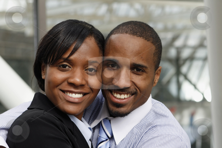 To use this stock image in your creative project, please select the size you need over to the right and click the "Add to Cart" button.
Your downloaded image will come with the Cutcaster watermark removed so don’t worry about the watermark you see on this page. Business Couple - Close-up stock photo, A businessman, dressed business causal, with his arm around a businesswoman dressed in a suit. The couple are standing very close to each other. by Orange Line Media