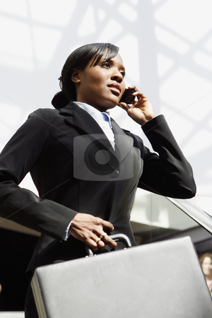 To use this stock image in your creative project, please select the size you need over to the right and click the "Add to Cart" button.
Your downloaded image will come with the Cutcaster watermark removed so don’t worry about the watermark you see on this page. Businesswoman on the Phone stock photo, Young attractive businesswoman talking on her cellphone, holding a briefcase. Vertically framed shot by Orange Line Media