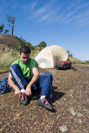 To use this stock image in your creative project, please select the size you need over to the right and click the "Add to Cart" button.
Your downloaded image will come with the Cutcaster watermark removed so don’t worry about the watermark you see on this page. Man Putting on Climbing Shoes stock photo, Attractive young man putting on his rock-climbing shoes in front of his tent by Orange Line Media
