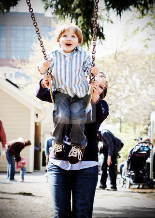 To use this stock image in your creative project, please select the size you need over to the right and click the "Add to Cart" button.
Your downloaded image will come with the Cutcaster watermark removed so don’t worry about the watermark you see on this page. Mother, Son and a Swingset 2 stock photo, Young boy being pushed high on a swing by his mother. Shot is focused on the boy at the start of his swing with the mother visible in the background. Vertical, high-contrast shot. by Orange Line Media
