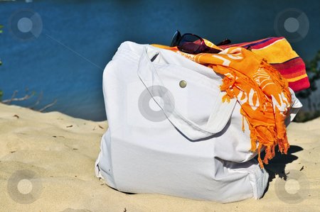 To use this stock image in your creative project, please select the size you need over to the right and click the "Add to Cart" button.
Your downloaded image will come with the Cutcaster watermark removed so don’t worry about the watermark you see on this page. Beach bags stock photo, Summer beach bag on sand with towels and sunglasses by Elena Elisseeva