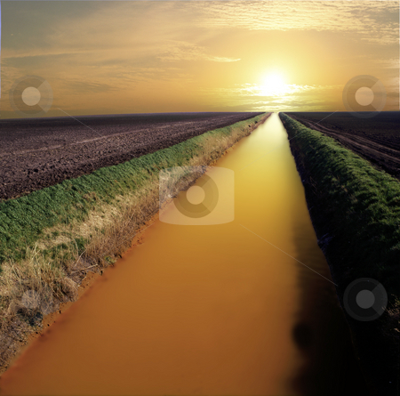 To use this stock image in your creative project, please select the size you need over to the right and click the "Add to Cart" button.
Your downloaded image will come with the Cutcaster watermark removed so don’t worry about the watermark you see on this page. River of gold stock photo, Straight and narrow river flowing towards infinity and the sunset. Looking like liquid gold by Paul Phillips