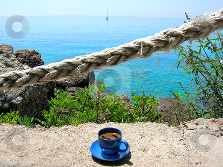 To use this stock image in your creative project, please select the size you need over to the right and click the "Add to Cart" button.
Your downloaded image will come with the Cutcaster watermark removed so don’t worry about the watermark you see on this page. Morning coffee on terrace stock photo, Cup of coffee on stone terrace in sea cafe with rope fence by Julija Sapic