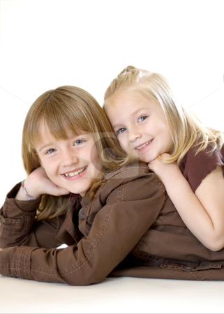 To use this stock image in your creative project, please select the size you need over to the right and click the "Add to Cart" button.
Your downloaded image will come with the Cutcaster watermark removed so don’t worry about the watermark you see on this page. Two Sisters Posing - Vertical stock photo, Two cute young sisters posing together in a studio. Vertically framed shot isolated against a white studio background. The older sister has her face resting on her hand. Both are smiling at the camera by Orange Line Media