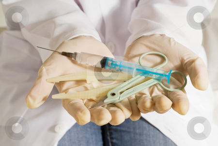 To use this stock image in your creative project, please select the size you need over to the right and click the "Add to Cart" button.
Your downloaded image will come with the Cutcaster watermark removed so don’t worry about the watermark you see on this page. Syringe, Scissors, Tongs - Horizontal, Isolated stock photo, A nurse's hands, with gloves on, holding medical supplies, such as a syringe, scissors, and tongs. by Orange Line Media