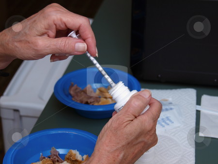 To use this stock image in your creative project, please select the size you need over to the right and click the "Add to Cart" button.
Your downloaded image will come with the Cutcaster watermark removed so don’t worry about the watermark you see on this page. Preparing a Shot - Horizontal stock photo, A woman preparing a shot of insulin at home. by Orange Line Media