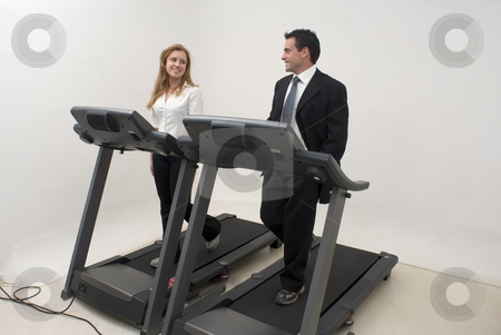 To use this stock image in your creative project, please select the size you need over to the right and click the "Add to Cart" button.
Your downloaded image will come with the Cutcaster watermark removed so don’t worry about the watermark you see on this page. Businesspeople on Treadmill - Horizontal stock photo, Two businesspeople (male and female) running on a treadmill and looking at each other and smiling by Orange Line Media