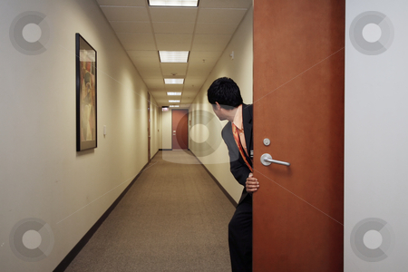 To use this stock image in your creative project, please select the size you need over to the right and click the "Add to Cart" button.
Your downloaded image will come with the Cutcaster watermark removed so don’t worry about the watermark you see on this page. Businessman Sneaking Around - Horizontal stock photo, Horizontally framed shot of a young businessman peering into an empty hallway through a doorway. He is facing away from the camera by Orange Line Media