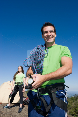 To use this stock image in your creative project, please select the size you need over to the right and click the "Add to Cart" button.
Your downloaded image will come with the Cutcaster watermark removed so don’t worry about the watermark you see on this page. Camping Couple stock photo, Attractive young man with climbing gear showing off his compass with an attractive woman in the background. Couple is enjoying a camping trip together. by Orange Line Media
