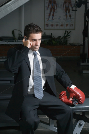 To use this stock image in your creative project, please select the size you need over to the right and click the "Add to Cart" button.
Your downloaded image will come with the Cutcaster watermark removed so don’t worry about the watermark you see on this page. Businessman, Gym, Cellphone stock photo, A shot of businessman in a gym, wearing a suit, taking a call on his cellphone. by Orange Line Media