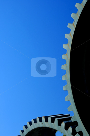 To use this stock image in your creative project, please select the size you need over to the right and click the "Add to Cart" button.
Your downloaded image will come with the Cutcaster watermark removed so don’t worry about the watermark you see on this page. Gears stock photo, Two old interlocking gear wheels, slightly rust-streaked, from some unidentifiable piece of machinery, set against a clear blue sky. Space for text. by Alistair Scott