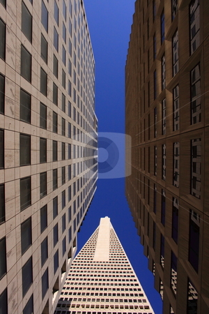 To use this stock image in your creative project, please select the size you need over to the right and click the "Add to Cart" button.
Your downloaded image will come with the Cutcaster watermark removed so don’t worry about the watermark you see on this page. Looking up between two highrise buildings stock photo, Architectural buildings of large city in a down town area, office locations by Richard Clack
