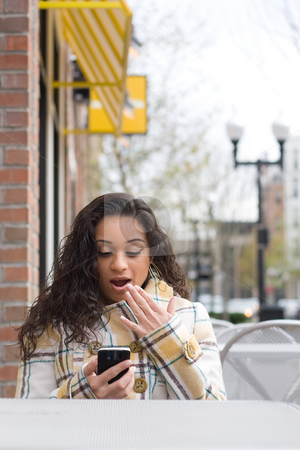 To use this stock image in your creative project, please select the size you need over to the right and click the "Add to Cart" button.
Your downloaded image will come with the Cutcaster watermark removed so don’t worry about the watermark you see on this page. Surprising Text Message stock photo, An attractive Indian woman texting or searching the web on her cell phone while seated at a table outdoors. by Todd Arena