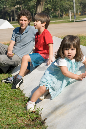 To use this stock image in your creative project, please select the size you need over to the right and click the "Add to Cart" button.
Your downloaded image will come with the Cutcaster watermark removed so don’t worry about the watermark you see on this page. Family Sitting in Park stock photo, Vertically framed outdoor shot of a father, his son, and his daugther sitting in a park on a sunny day. by Orange Line Media