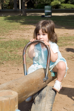 To use this stock image in your creative project, please select the size you need over to the right and click the "Add to Cart" button.
Your downloaded image will come with the Cutcaster watermark removed so don’t worry about the watermark you see on this page. Cute Little Girl stock photo, Adorable little girl playing on a see-saw. Vertically framed shot. by Orange Line Media