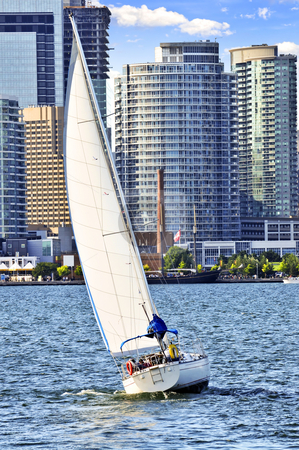 To use this stock image in your creative project, please select the size you need over to the right and click the "Add to Cart" button.
Your downloaded image will come with the Cutcaster watermark removed so don’t worry about the watermark you see on this page. Sailboat in Toronto harbor stock photo, Sailboat sailing in Toronto harbour with downtown view by Elena Elisseeva