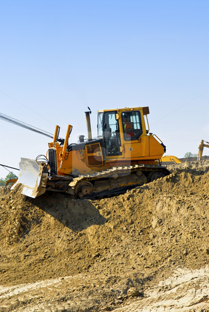 To use this stock image in your creative project, please select the size you need over to the right and click the "Add to Cart" button.
Your downloaded image will come with the Cutcaster watermark removed so don’t worry about the watermark you see on this page. Construction site machines stock photo, Yellow bulldozer machines digging and moving earth at construction site by Elena Elisseeva
