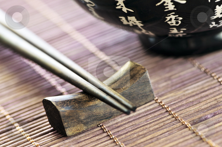 To use this stock image in your creative project, please select the size you need over to the right and click the "Add to Cart" button.
Your downloaded image will come with the Cutcaster watermark removed so don’t worry about the watermark you see on this page. Rice bowl and chopsticks stock photo, Asian rice bowl and wooden chopsticks on a rest close up by Elena Elisseeva