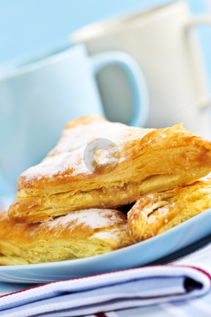 To use this stock image in your creative project, please select the size you need over to the right and click the "Add to Cart" button.
Your downloaded image will come with the Cutcaster watermark removed so don’t worry about the watermark you see on this page. Apple turnovers pastries stock photo, Apple turnovers pastries with coffee cups in the background by Elena Elisseeva
