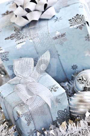 To use this stock image in your creative project, please select the size you need over to the right and click the "Add to Cart" button.
Your downloaded image will come with the Cutcaster watermark removed so don’t worry about the watermark you see on this page. Christmas gift boxes stock photo, Wrapped gift boxes with silver Christmas ornaments by Elena Elisseeva