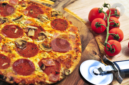 To use this stock image in your creative project, please select the size you need over to the right and click the "Add to Cart" button.
Your downloaded image will come with the Cutcaster watermark removed so don’t worry about the watermark you see on this page. Pepperoni pizza stock photo, Freshly baked pepperoni pizza on wooden board by Elena Elisseeva
