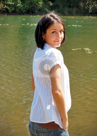 To use this stock image in your creative project, please select the size you need over to the right and click the "Add to Cart" button.
Your downloaded image will come with the Cutcaster watermark removed so don’t worry about the watermark you see on this page. Cute Brunette by the River stock photo, Attractive young woman standing by a river bank and looking back over her shoulder at the camera. Vertically framed shot. by Orange Line Media