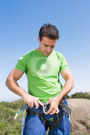 To use this stock image in your creative project, please select the size you need over to the right and click the "Add to Cart" button.
Your downloaded image will come with the Cutcaster watermark removed so don’t worry about the watermark you see on this page. Attaching Rope to Climbing Harness - Vertical stock photo, Athletic young man attaching a climbing rope to his climbing harness. Vertically framed shot against a clear blue sky. Vertically framed shot by Orange Line Media