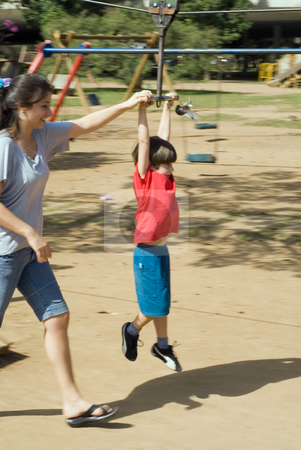 To use this stock image in your creative project, please select the size you need over to the right and click the "Add to Cart" button.
Your downloaded image will come with the Cutcaster watermark removed so don’t worry about the watermark you see on this page. Mother Playing with Her Son stock photo, Vertically framed outdoor shot of a mother helping her son ride a zip line. by Orange Line Media