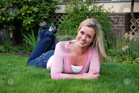 To use this stock image in your creative project, please select the size you need over to the right and click the "Add to Cart" button.
Your downloaded image will come with the Cutcaster watermark removed so don’t worry about the watermark you see on this page. Beautiful Woman in Field stock photo, Attractive young woman lying on a lush green lawn and smiling at the camera. Horizontally framed shot by Orange Line Media