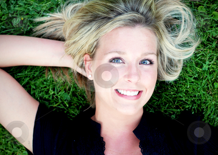 To use this stock image in your creative project, please select the size you need over to the right and click the "Add to Cart" button.
Your downloaded image will come with the Cutcaster watermark removed so don’t worry about the watermark you see on this page. Cute Blond on the Grass stock photo, Attractive blond woman lying on a lush green lawn smiling at the camera. Horizontally framed close-up shot. by Orange Line Media