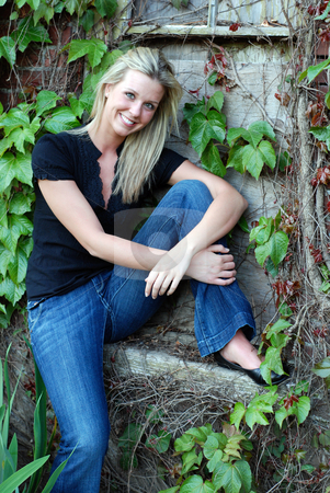 To use this stock image in your creative project, please select the size you need over to the right and click the "Add to Cart" button.
Your downloaded image will come with the Cutcaster watermark removed so don’t worry about the watermark you see on this page. Attractive Blond Woman stock photo, Attractive young blond woman casually dressed smiling at the camera sitting by an ivy covered stone and brick wall by Orange Line Media