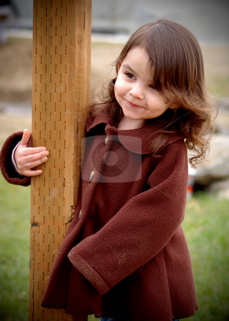 To use this stock image in your creative project, please select the size you need over to the right and click the "Add to Cart" button.
Your downloaded image will come with the Cutcaster watermark removed so don’t worry about the watermark you see on this page. Cute Girl Smiling stock photo, Cute young girl in a brown coat smiling as she holds on to a fence post outdoors by Orange Line Media