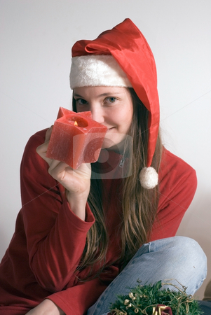 To use this stock image in your creative project, please select the size you need over to the right and click the "Add to Cart" button.
Your downloaded image will come with the Cutcaster watermark removed so don’t worry about the watermark you see on this page. Woman with Christmas Candle stock photo, Attractive woman in a santa hat holding a red Christmas candle by Orange Line Media