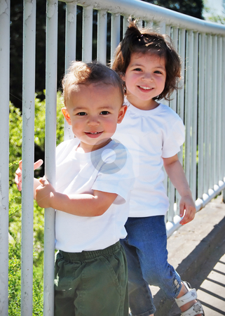 To use this stock image in your creative project, please select the size you need over to the right and click the "Add to Cart" button.
Your downloaded image will come with the Cutcaster watermark removed so don’t worry about the watermark you see on this page. Brother and Sister stock photo, Cute young brother and sister playing together by a guardrail on a sunny day. Vertically framed shot. by Orange Line Media