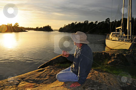 To use this stock image in your creative project, please select the size you need over to the right and click the "Add to Cart" button.
Your downloaded image will come with the Cutcaster watermark removed so don’t worry about the watermark you see on this page. Enjoy life stock photo, Sailor enjoys a whiskey watching the sunset by Magnus Johansson