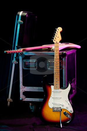 To use this stock image in your creative project, please select the size you need over to the right and click the "Add to Cart" button.
Your downloaded image will come with the Cutcaster watermark removed so don’t worry about the watermark you see on this page. Two electric guitars with a crate and a case on a stage with lig stock photo, Two electric guitars with a crate and a case on a stage with lights by Vince Clements