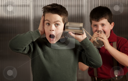 To use this stock image in your creative project, please select the size you need over to the right and click the "Add to Cart" button.
Your downloaded image will come with the Cutcaster watermark removed so don’t worry about the watermark you see on this page. Little boy getting shocking message on tin can phone stock photo, Little boy getting shocking message from friend on tin can phone by Scott Griessel