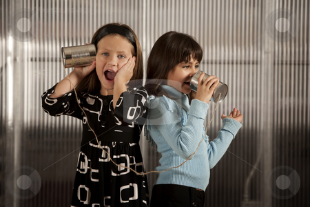 To use this stock image in your creative project, please select the size you need over to the right and click the "Add to Cart" button.
Your downloaded image will come with the Cutcaster watermark removed so don’t worry about the watermark you see on this page. Little girl getting shocking message on tin can phone stock photo, Little gril getting shocking message from friend on tin can phone by Scott Griessel