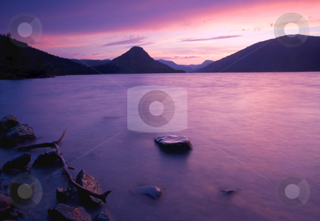 To use this stock image in your creative project, please select the size you need over to the right and click the "Add to Cart" button.
Your downloaded image will come with the Cutcaster watermark removed so don’t worry about the watermark you see on this page. Rimrock Sunset stock photo, A colorful sunset over the waters of Rimrock Lake by Mike Dawson