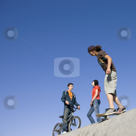 To use this stock image in your creative project, please select the size you need over to the right and click the "Add to Cart" button.
Your downloaded image will come with the Cutcaster watermark removed so don’t worry about the watermark you see on this page. Tricks at skate park stock photo, Kids hang out and do tricks at the skatepark by Rick Becker-Leckrone