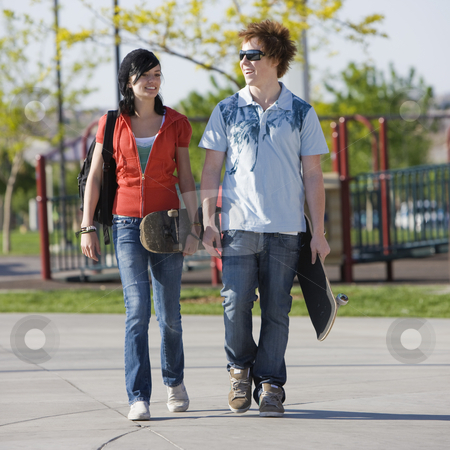 To use this stock image in your creative project, please select the size you need over to the right and click the "Add to Cart" button.
Your downloaded image will come with the Cutcaster watermark removed so don’t worry about the watermark you see on this page. Teens couple walks stock photo, Two kids walk home through a park by Rick Becker-Leckrone