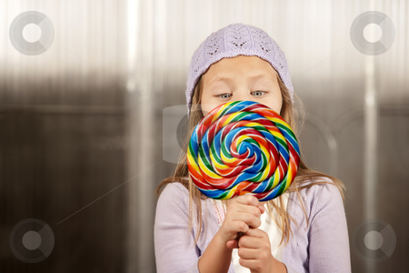 To use this stock image in your creative project, please select the size you need over to the right and click the "Add to Cart" button.
Your downloaded image will come with the Cutcaster watermark removed so don’t worry about the watermark you see on this page. Little girl with a lollipop stock photo, Cute young girl golding colorful lollipop by Scott Griessel