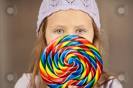 To use this stock image in your creative project, please select the size you need over to the right and click the "Add to Cart" button.
Your downloaded image will come with the Cutcaster watermark removed so don’t worry about the watermark you see on this page. Little girl with a lollipop stock photo, Cute young girl golding colorful lollipop by Scott Griessel