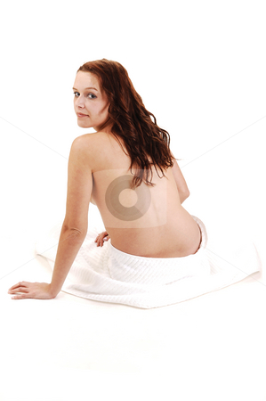 To use this stock image in your creative project, please select the size you need over to the right and click the "Add to Cart" button.
Your downloaded image will come with the Cutcaster watermark removed so don’t worry about the watermark you see on this page. Young woman sitting. stock photo, A young nude woman sitting on the floor with a white towel around her
bottom, shooing her back and looking at the camera. by Horst Petzold