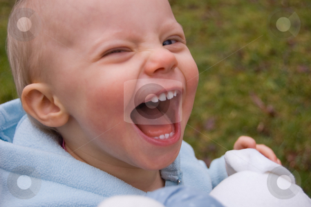 To use this stock image in your creative project, please select the size you need over to the right and click the "Add to Cart" button.
Your downloaded image will come with the Cutcaster watermark removed so don’t worry about the watermark you see on this page. Young Child Laughing Out Loud stock photo, A young child is laughing out loud while holding a stuffed toy for contagious laughter. by Valerie Garner